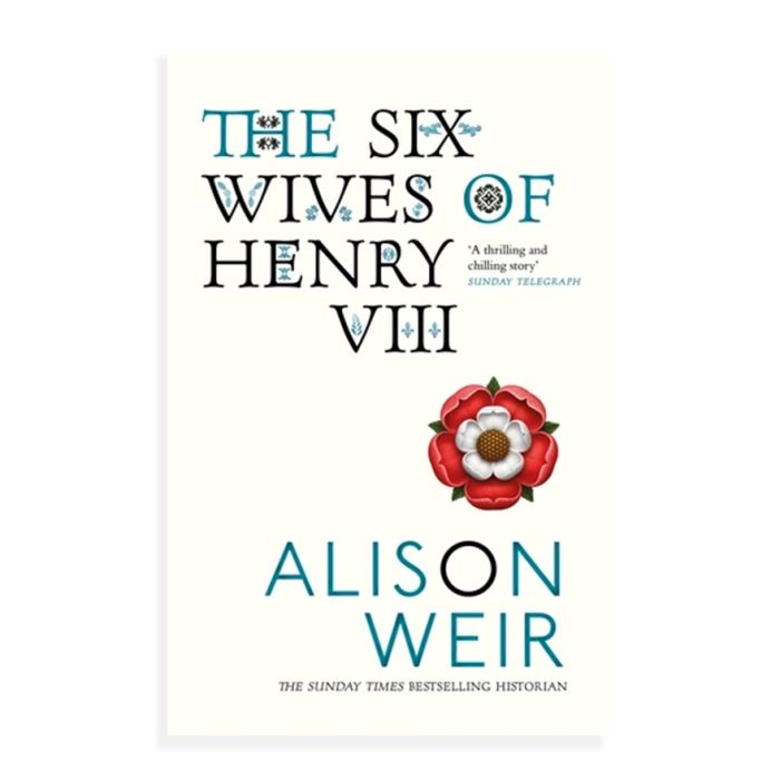 A cream book cover with black and teal writing that reads, The Six Wives of Henry VIII. There is an illustrated Tudor rose in red and white below. 