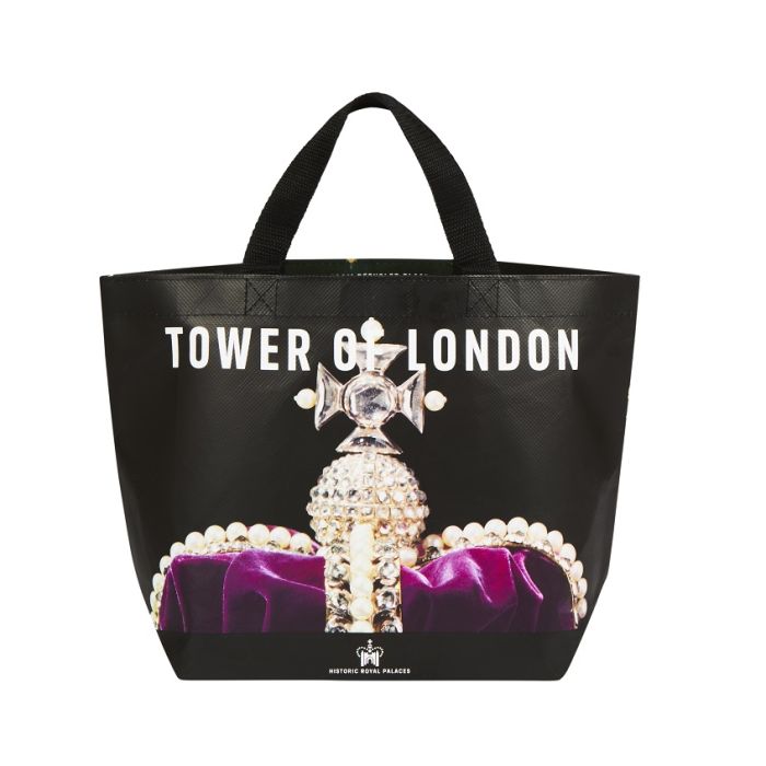 A black tote bag with image a printed image of a royal crown alongside the words, Tower of London in white. 