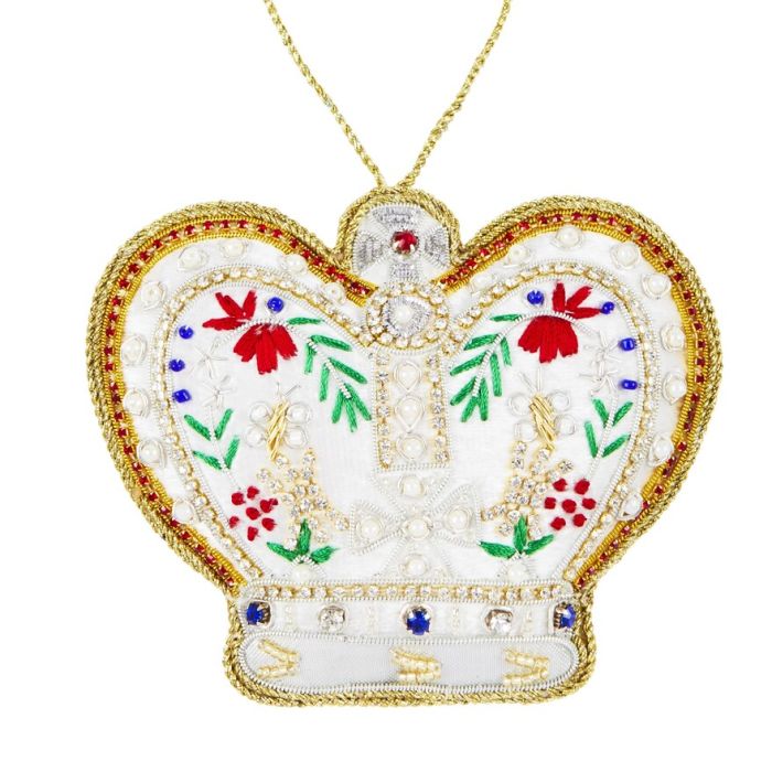 A white crown shaped fabric hanging decoration featuring a floral design, coloured gems, beads and faux pearls 