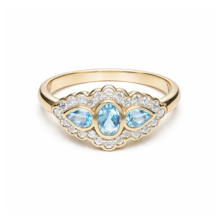 A yellow gold ring with a cluster pendant of three aquamarine stones surrounded by diamonds. 