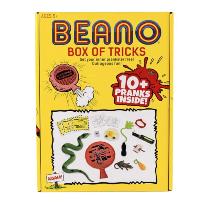 A bright yellow Beano comic box with a selection of different toys to play pranks inside.