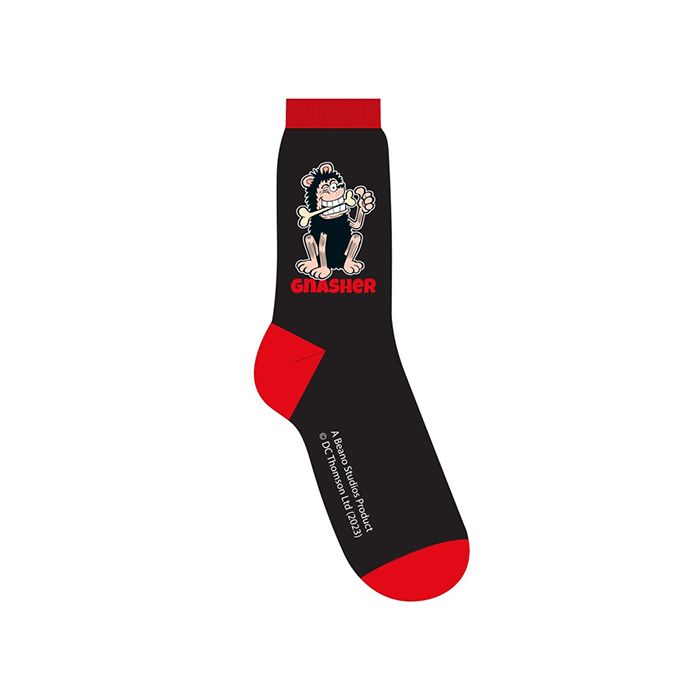 A pair of black socks with contrasting red toe, heel and cuff sections. Printed with a comic book illustration of Gnasher the dog chewing a bone from the Beano,