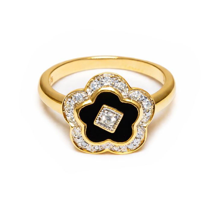 A yellow gold ring with a flower pendant with a central diamond, surrounded by a black onyx stone, and then surrounded by a further ring of diamonds. 
