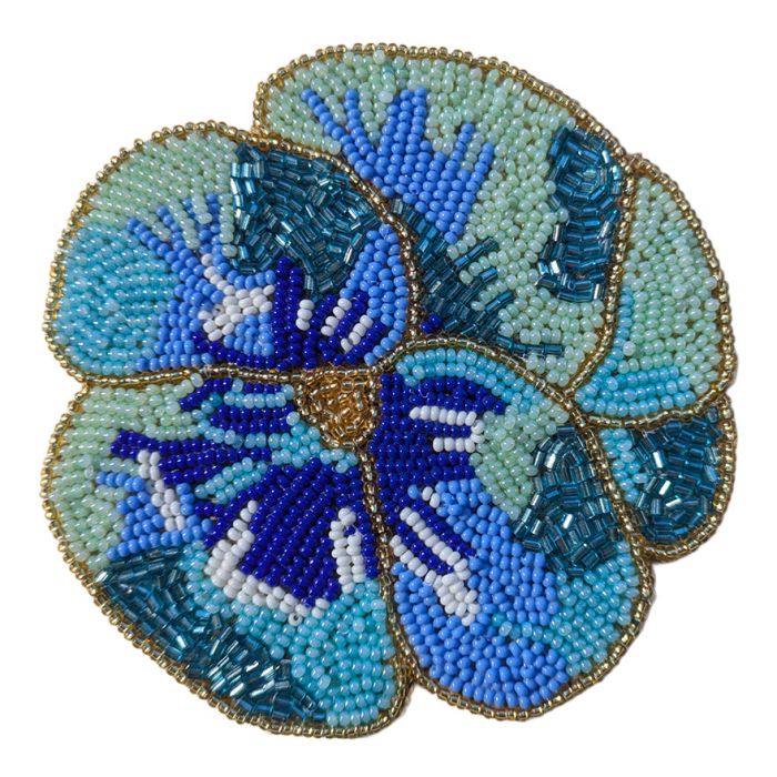A beaded coaster in the shape of a pansy flower with blue, turquoise and gold beads. 