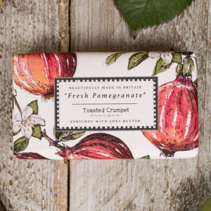 Pomegranate soap bar in illustrated packaging with fruit and floral design
