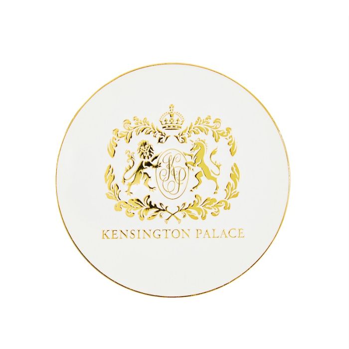 White round coaster with gold edge and crest of Kensington Palace