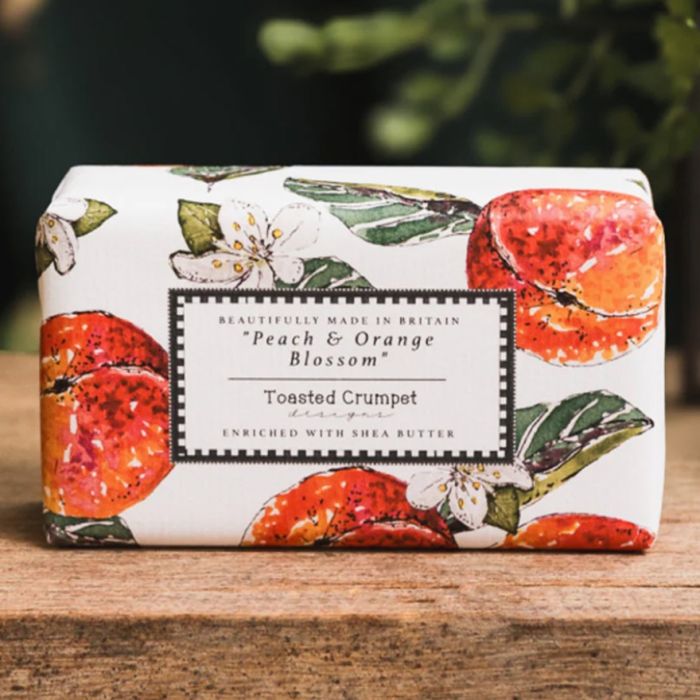 Peach and orange blossom soap bar in illustrated packaging with fruit and floral design