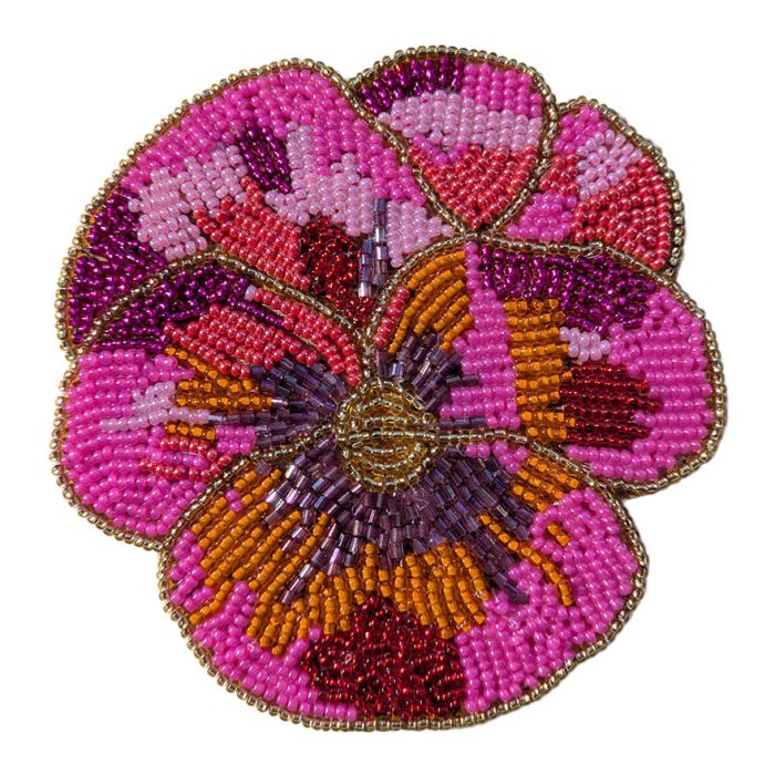 A beaded coaster in the shape of a flower with pink, orange, purple and gold beads.