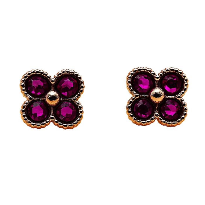 Pink and gold clover stud earrings with a cream background.