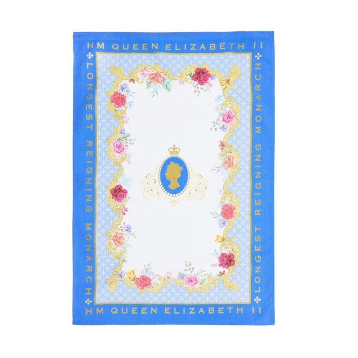A blue and white tea towel featuring images of colourful roses and 'HM Queen Elizabeth II Longest Reigning Monarch' text in gold