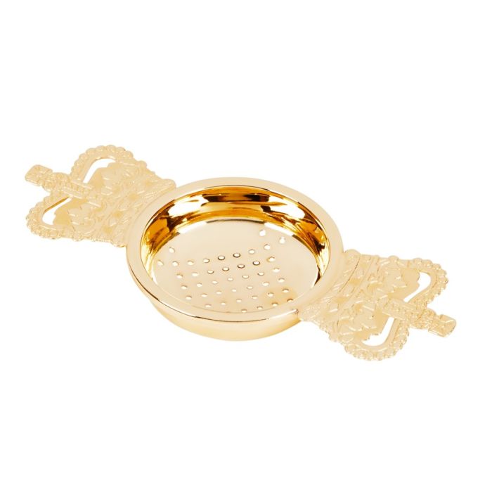 A gold-plated tea strainer with crown motif handles on both sides. 