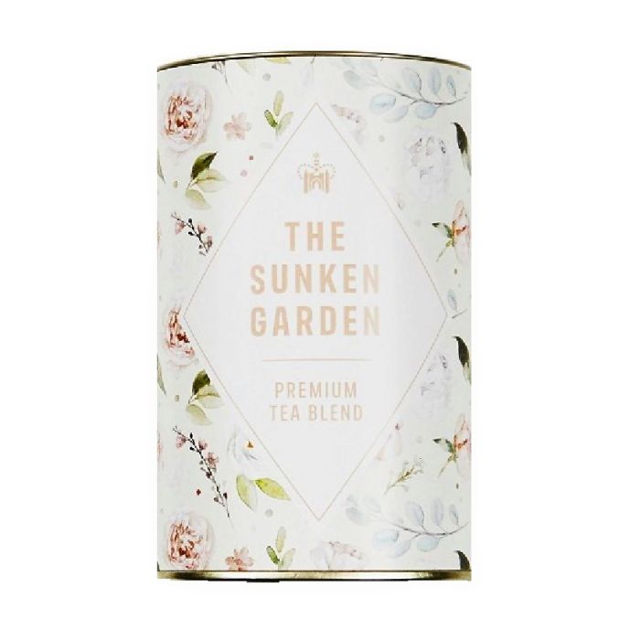 A circular tin of "The Sunken Garden, Premium blend tea" with a watercolour pattern of flowers and leaves on it. 