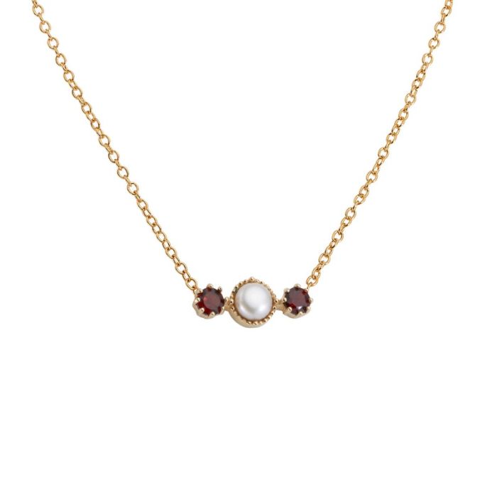 A gold necklace with a cluster of three stones - two red garnets either side and a pearl in the centre. 