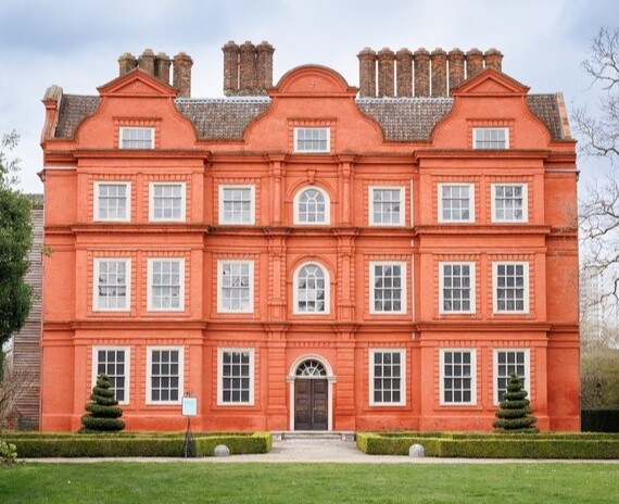 The front of Kew Palace showing the red fa&ccedil;ade and white window frames. 